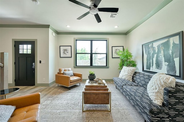 living room featuring plenty of natural light, wood finished floors, visible vents, and baseboards