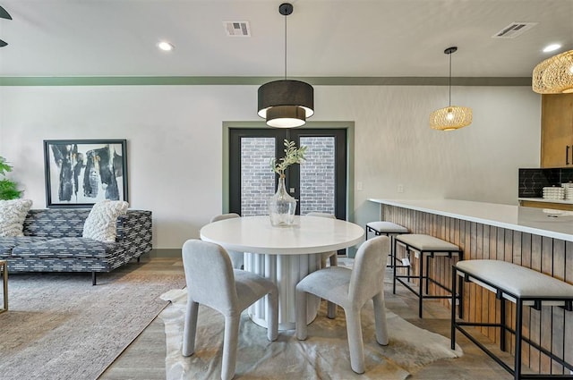 dining space featuring wood finished floors, visible vents, and recessed lighting