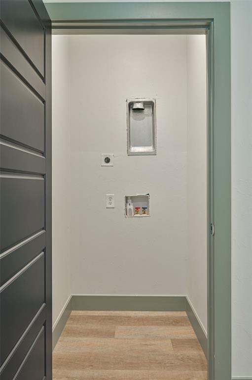 laundry area featuring hookup for a washing machine, electric dryer hookup, wood finished floors, laundry area, and baseboards