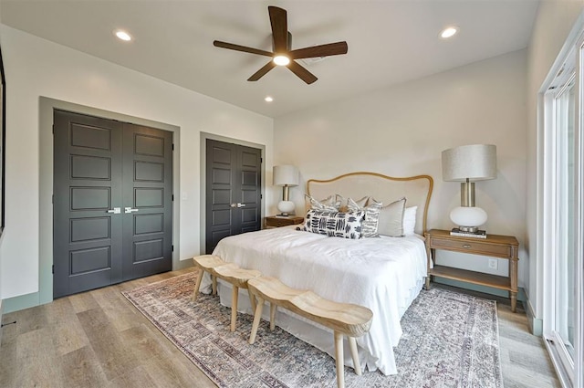 bedroom with a ceiling fan, recessed lighting, baseboards, and wood finished floors