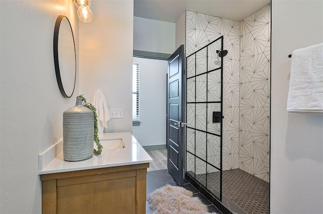 full bathroom with double vanity and a walk in shower