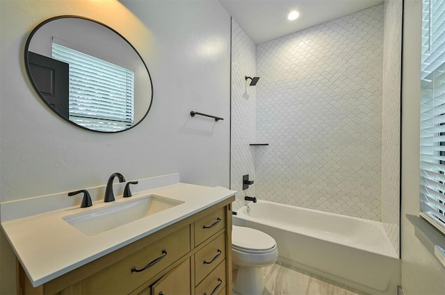 bathroom with bathing tub / shower combination, toilet, and vanity