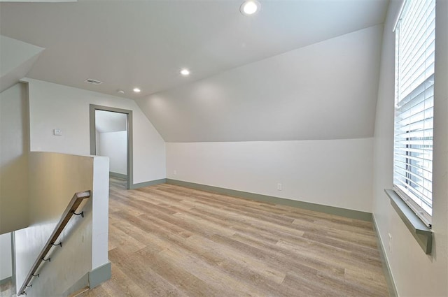 bonus room featuring light wood-type flooring, a healthy amount of sunlight, vaulted ceiling, and recessed lighting