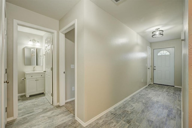 entrance foyer featuring light wood-style floors and baseboards