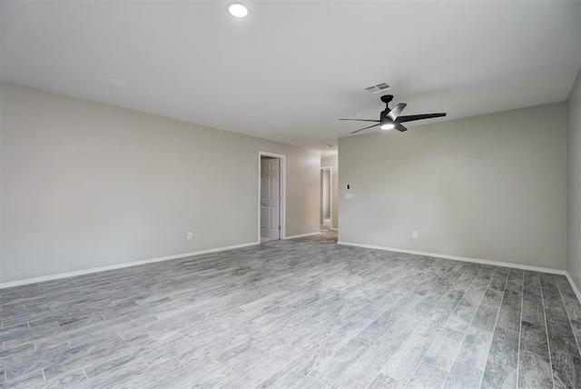 unfurnished room featuring baseboards, visible vents, and light wood-style floors