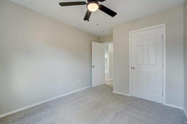 unfurnished bedroom featuring carpet floors, ceiling fan, and baseboards