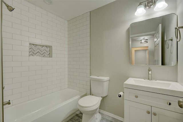 bathroom featuring shower / bath combination, vanity, toilet, and baseboards