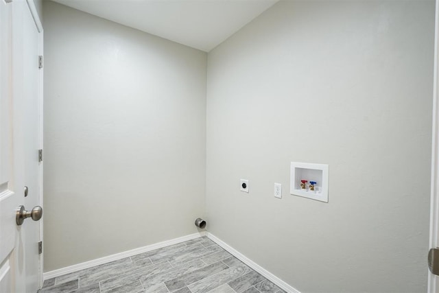 laundry room featuring hookup for a washing machine, laundry area, baseboards, light wood finished floors, and electric dryer hookup