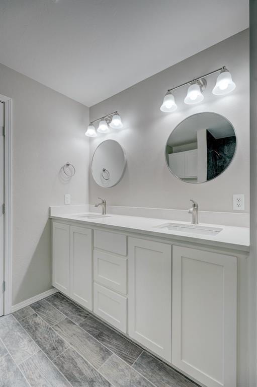 full bath with a sink and double vanity