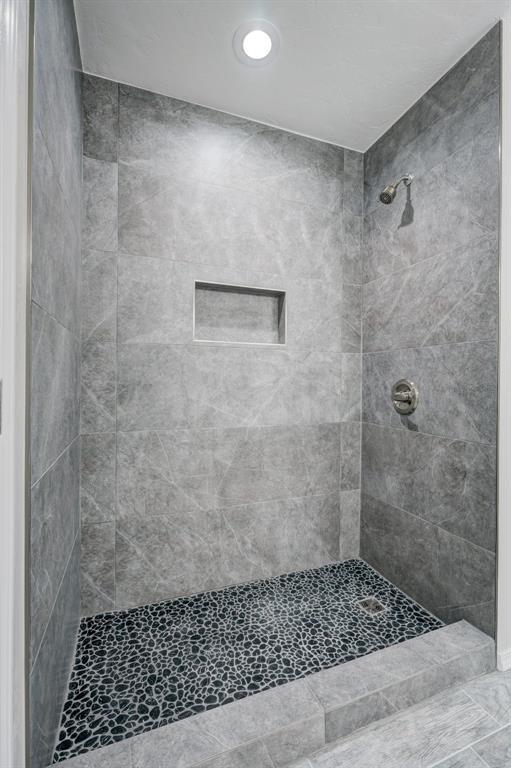 bathroom with a tile shower