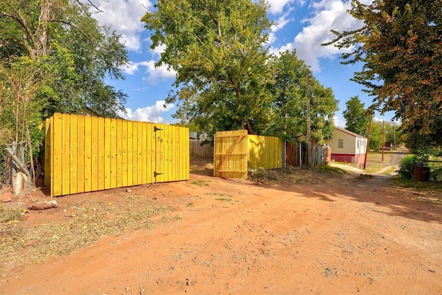 view of yard with fence and a gate