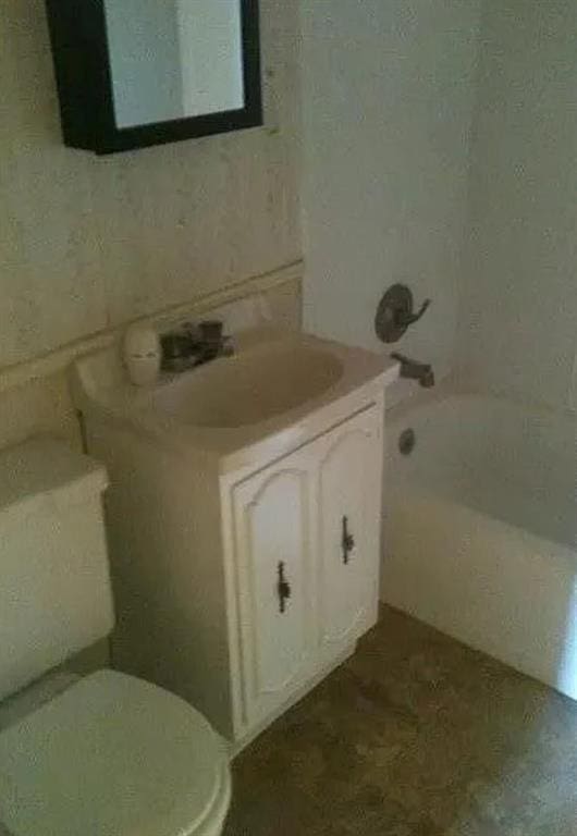 full bath with vanity,  shower combination, and toilet