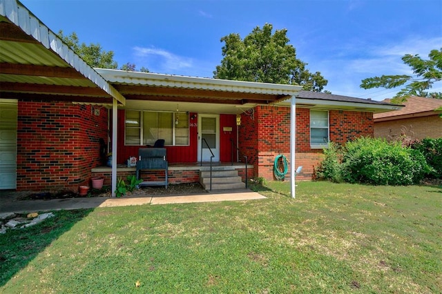 view of front of property featuring a front yard, a porch, and brick siding