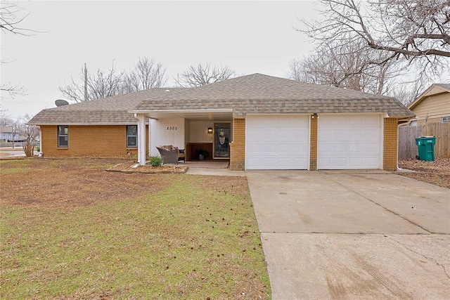 ranch-style home with concrete driveway, brick siding, an attached garage, and a shingled roof