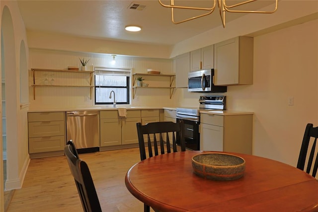 dining space featuring light wood-style floors, visible vents, and an inviting chandelier