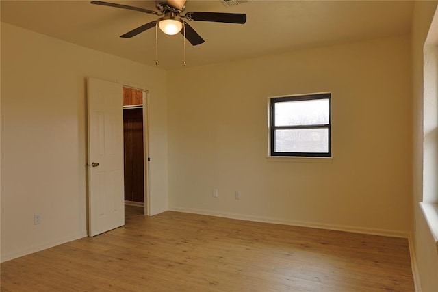 unfurnished room featuring light wood-type flooring, baseboards, visible vents, and a ceiling fan