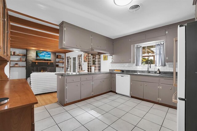 kitchen featuring dark countertops, white appliances, and gray cabinetry