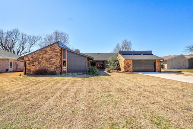 mid-century inspired home featuring driveway, a front lawn, an attached garage, and stone siding