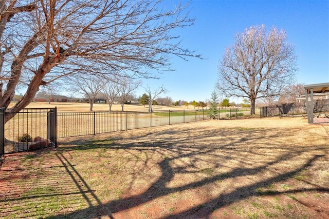 view of yard with a rural view and fence