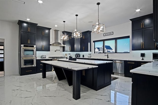 kitchen with stainless steel appliances, marble finish floor, dark cabinetry, a center island, and wall chimney exhaust hood