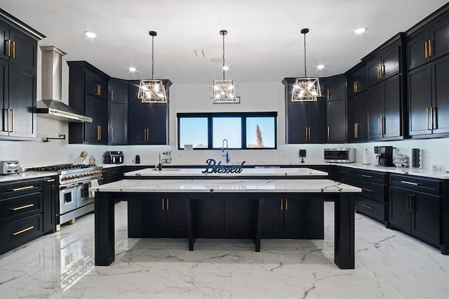 kitchen featuring a large island, light stone countertops, dark cabinetry, wall chimney range hood, and double oven range