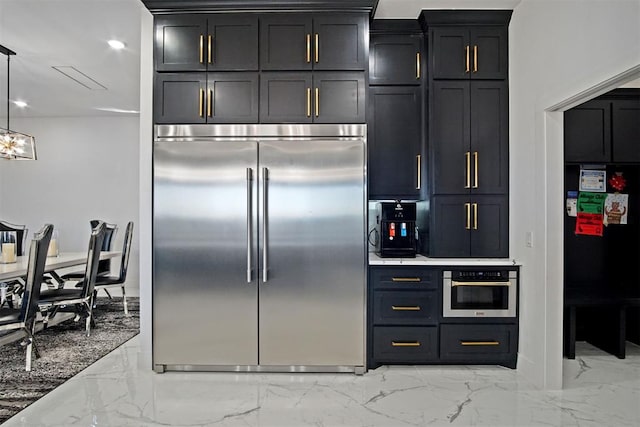 kitchen featuring marble finish floor, pendant lighting, recessed lighting, appliances with stainless steel finishes, and dark cabinets