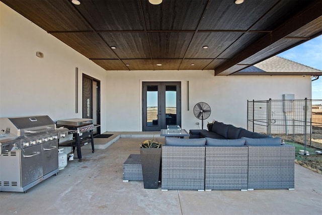 view of patio with french doors, fence, area for grilling, and an outdoor hangout area