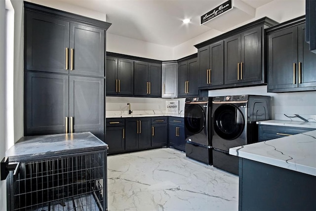 washroom with cabinet space, marble finish floor, separate washer and dryer, a sink, and recessed lighting