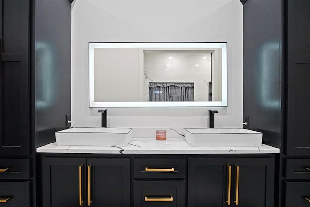 full bath featuring double vanity and a sink