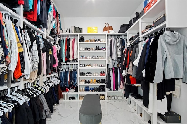 spacious closet featuring marble finish floor