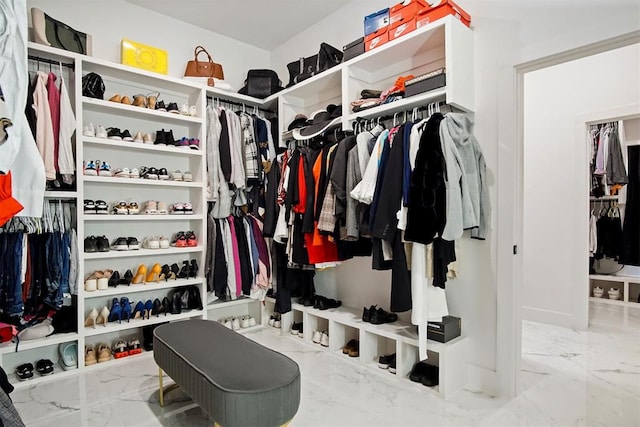 spacious closet featuring marble finish floor