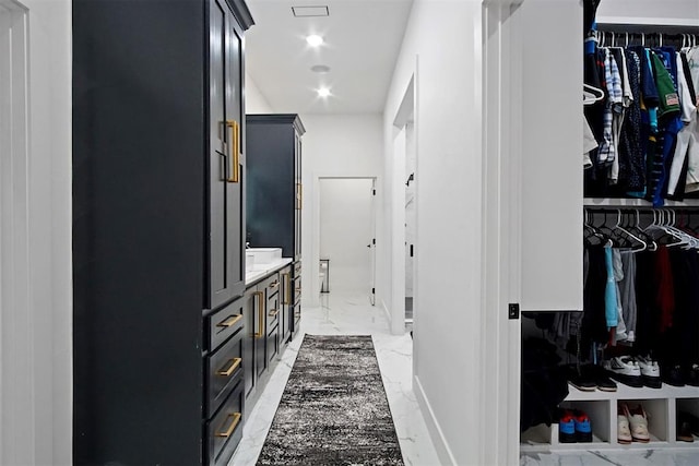 hallway with marble finish floor and recessed lighting