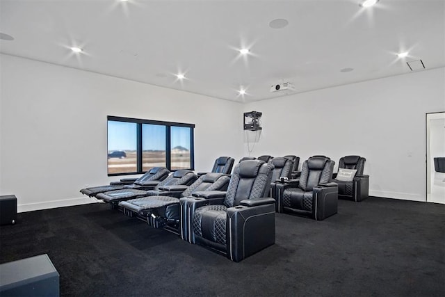 cinema room with recessed lighting, dark carpet, and baseboards