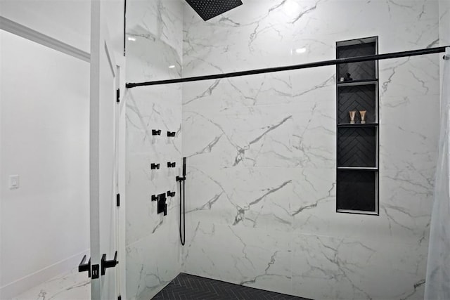 full bath featuring marble finish floor and a marble finish shower