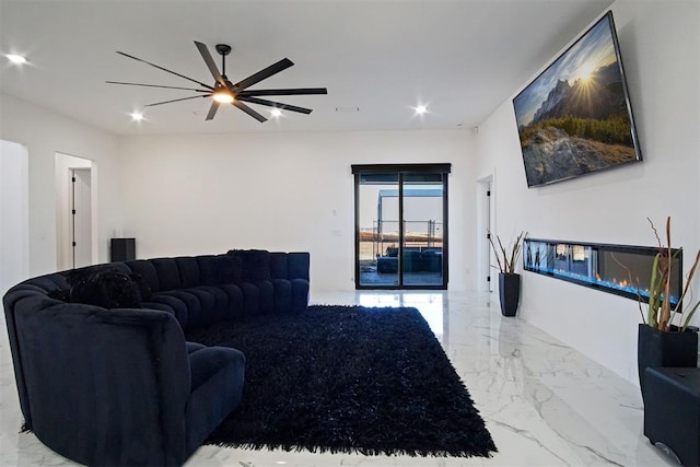 living room with ceiling fan, marble finish floor, a glass covered fireplace, and recessed lighting