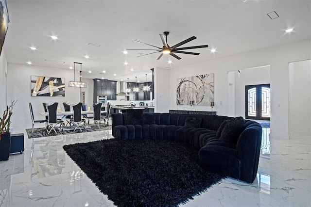 living room with marble finish floor, french doors, and recessed lighting