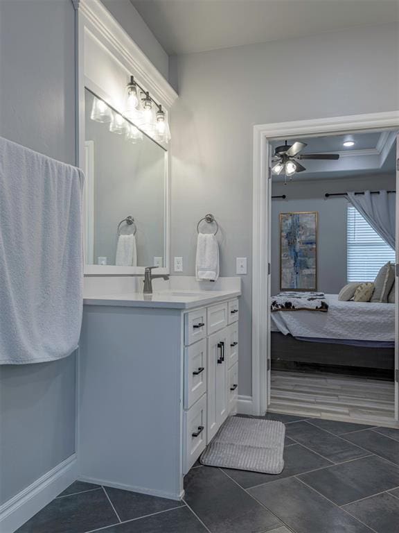 bathroom featuring a ceiling fan, tile patterned floors, vanity, and ensuite bathroom