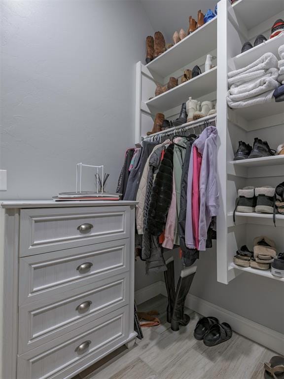 spacious closet with light wood finished floors