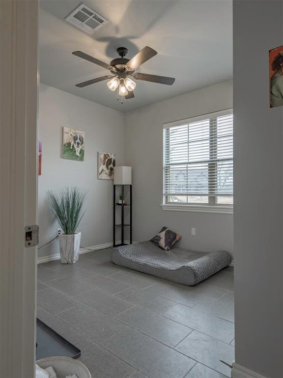 bedroom featuring ceiling fan, visible vents, and baseboards