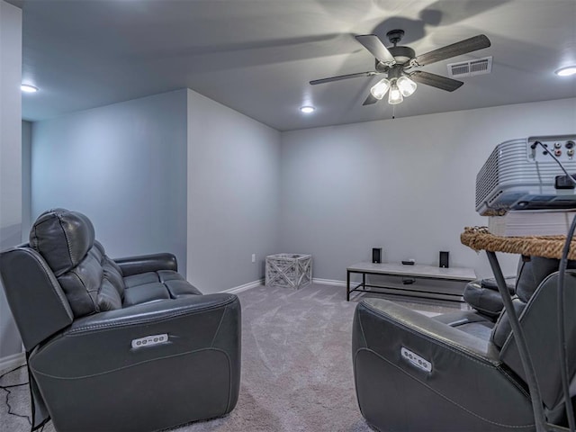 interior space with a ceiling fan, light carpet, visible vents, and baseboards