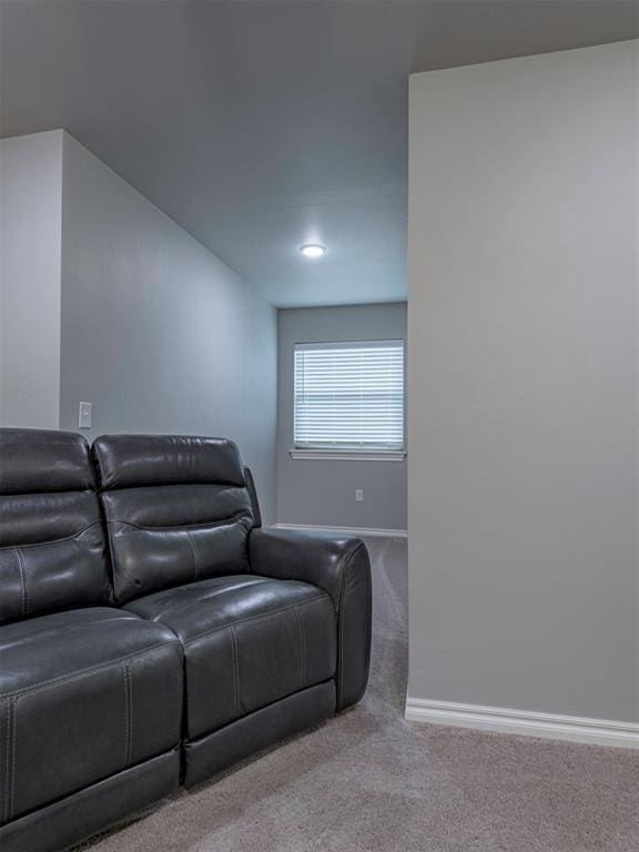 carpeted home theater room with baseboards