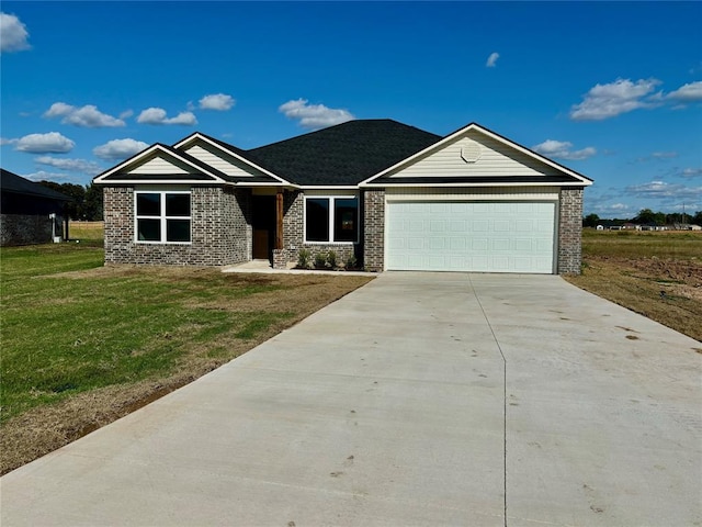 ranch-style home featuring a front yard, concrete driveway, brick siding, and an attached garage