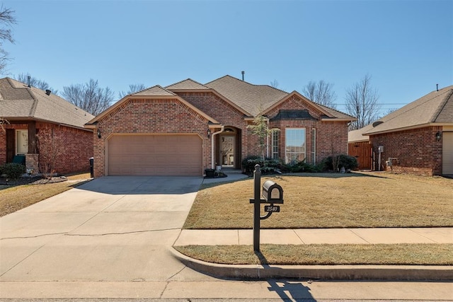 view of front of home featuring an attached garage, brick siding, a shingled roof, concrete driveway, and a front lawn