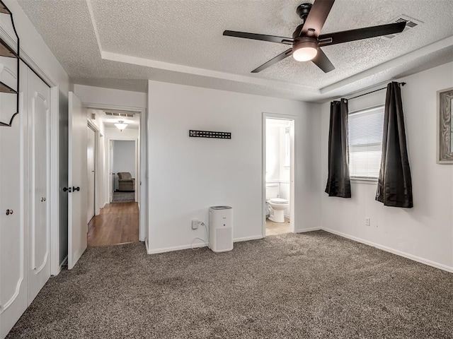 unfurnished bedroom with a closet, carpet flooring, a textured ceiling, and baseboards