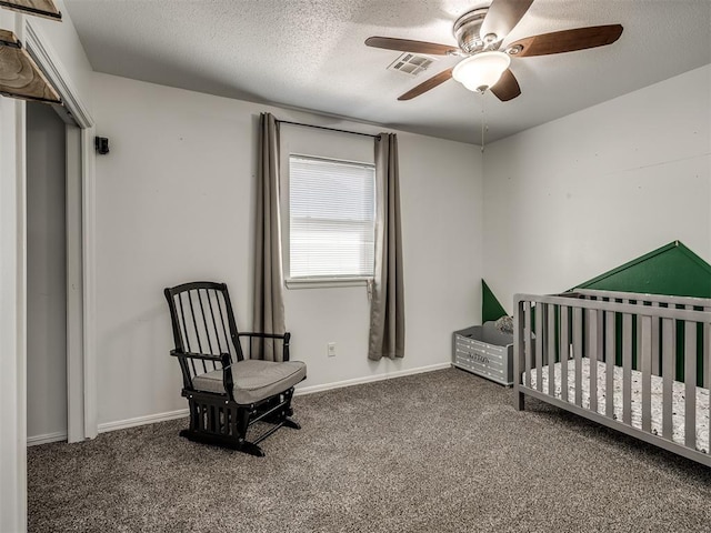 carpeted bedroom featuring a ceiling fan, baseboards, visible vents, and a textured ceiling