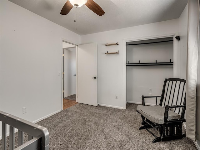 carpeted bedroom featuring a textured ceiling, a ceiling fan, and baseboards