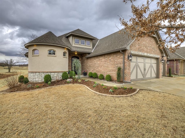 view of front of property featuring a garage, brick siding, concrete driveway, and roof with shingles