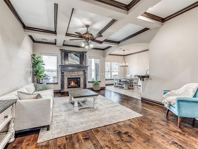 living area with ornamental molding, hardwood / wood-style floors, coffered ceiling, and a fireplace