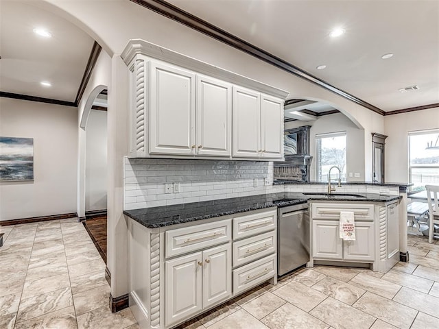 kitchen featuring arched walkways, a sink, visible vents, dishwasher, and crown molding