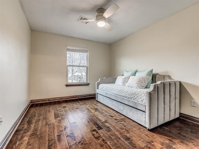 bedroom featuring hardwood / wood-style floors, a ceiling fan, and baseboards